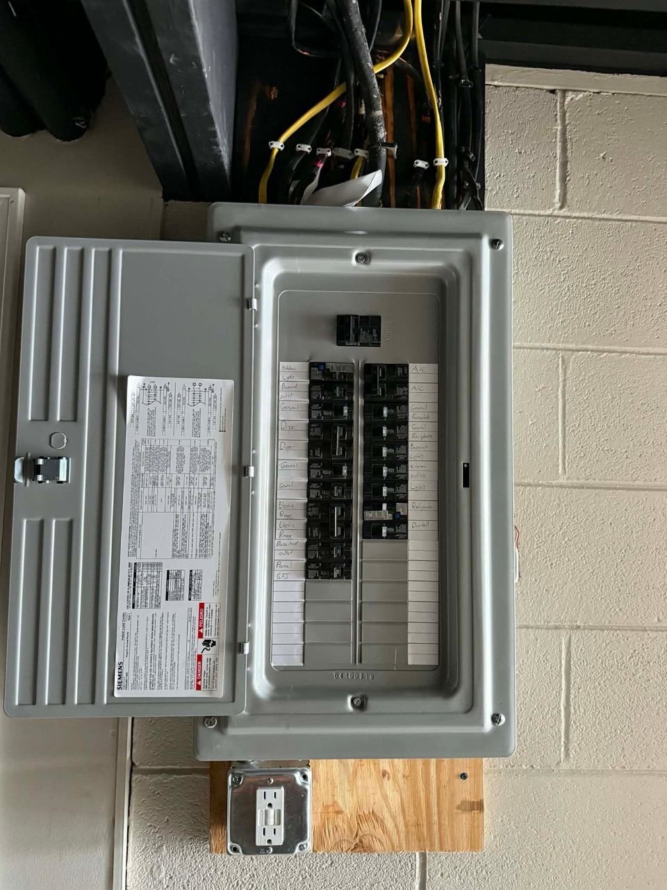 A newly installed breaker panel, door open, circuits labeled